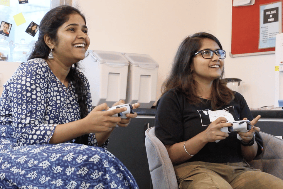 Two girls playing games on playstation